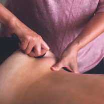 a Gua Sha treatment on a person's back