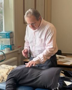 A photo of Marek giving a treatment to a patient